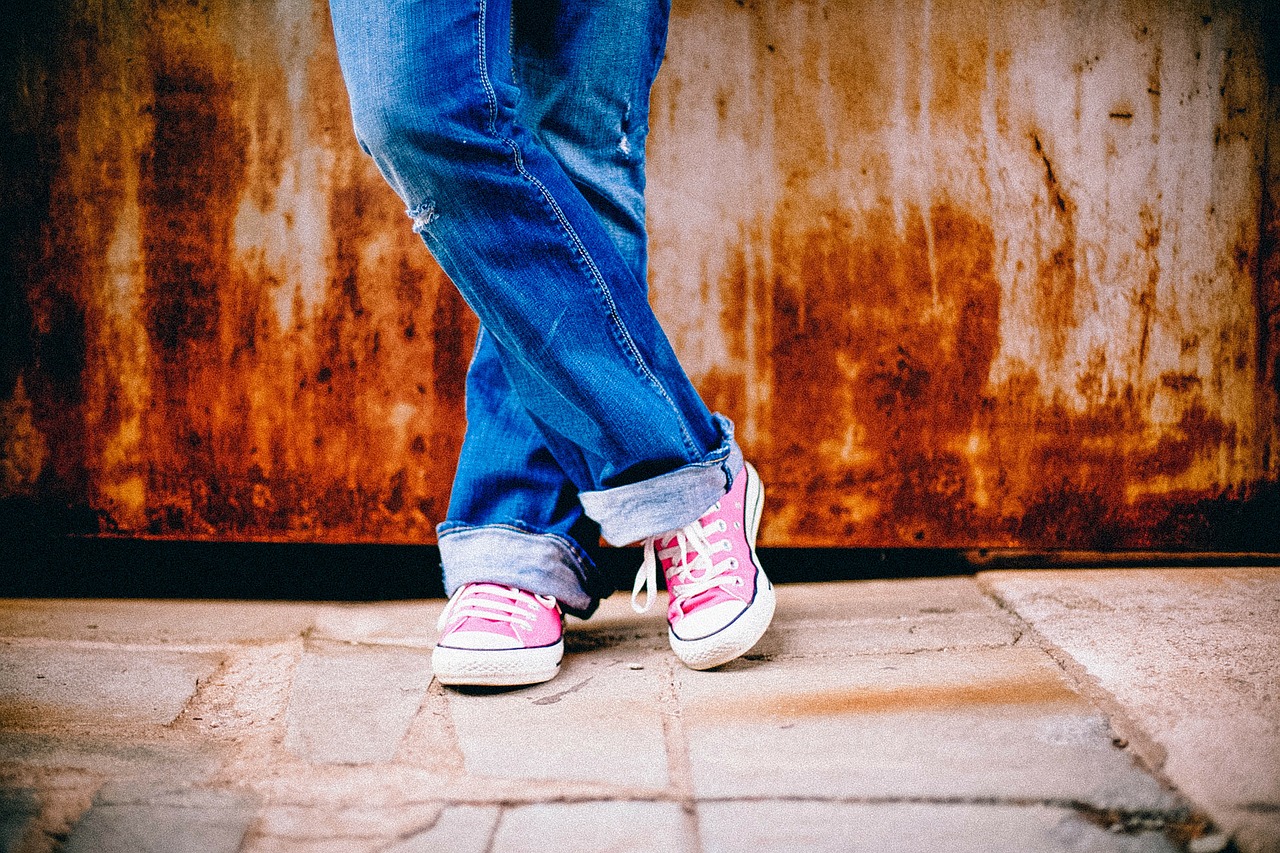 feet with pink canvas shoes