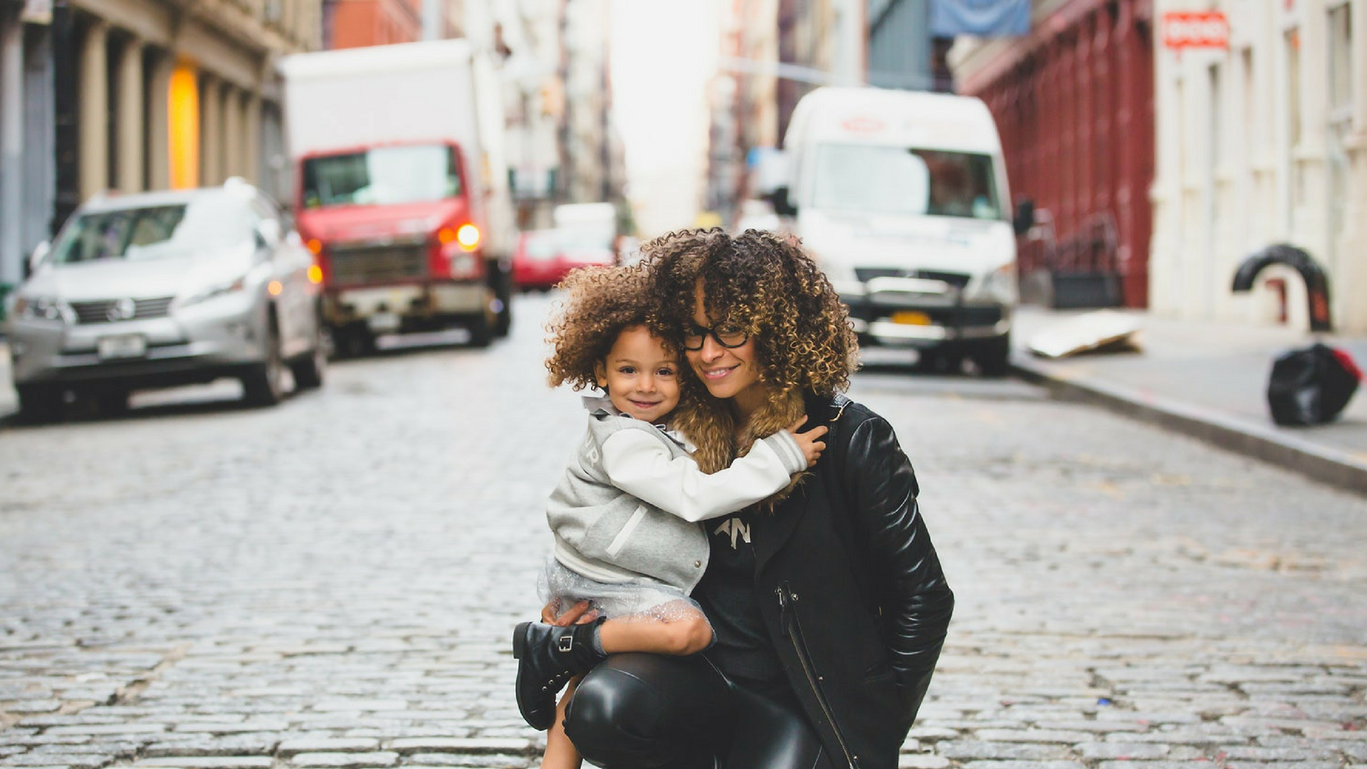 woman and confident child sitting on road